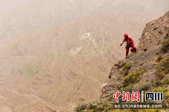 抛绳问路,物探员工准备下到陡崖上艰险作业。王智 摄 抛绳问路,物探员工准备下到陡崖上艰险作业。王智 摄