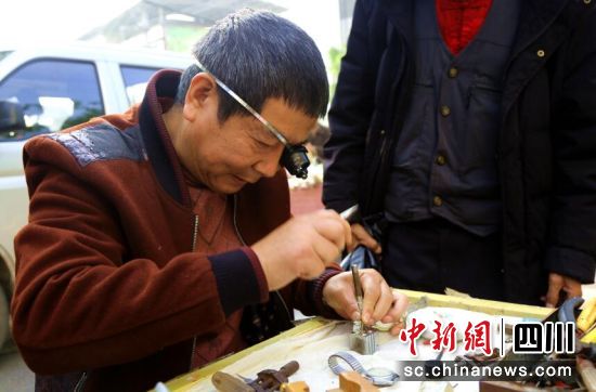 李远彬用修表锤和生耳批维修表带。泸县融媒体中心供图 李远彬用修表锤和生耳批维修表带。泸县融媒体中心供图