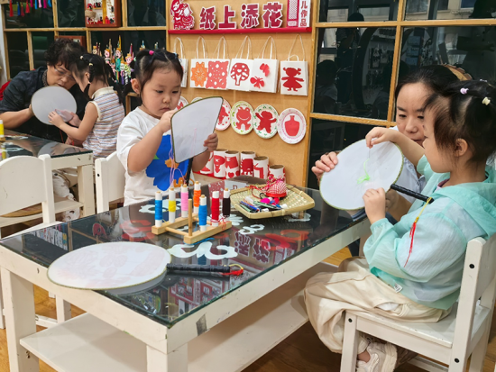 北川羌族自治县安昌幼儿园孩童在老师指导下进行刺绣 摄影 薛雨桢 北川羌族自治县安昌幼儿园孩童在老师指导下进行刺绣 摄影 薛雨桢