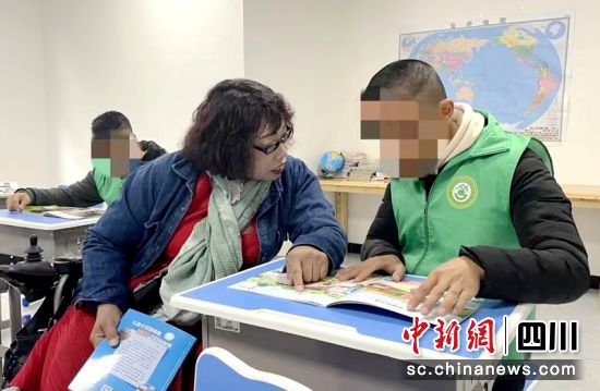 青神县残疾人托养中心工作人员辅导残疾人。青神融媒供图 青神县残疾人托养中心工作人员辅导残疾人。青神融媒供图