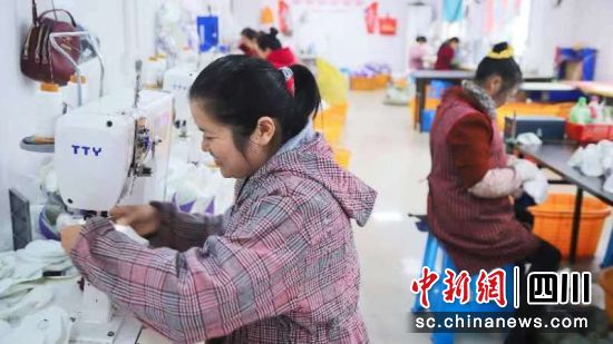 罗进在工位上进行鞋面加工。潘政吉 摄 罗进在工位上进行鞋面加工。潘政吉 摄