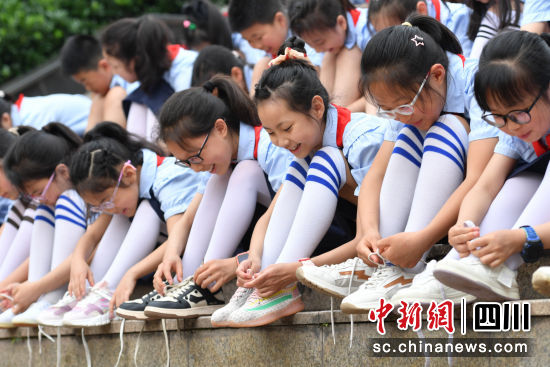 学生在进行系鞋带比赛。彭圣洲 摄 学生在进行系鞋带比赛。彭圣洲 摄