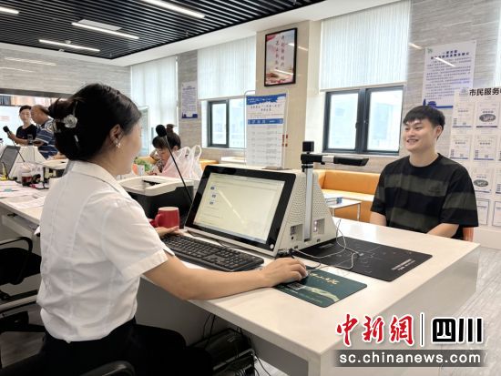 工作人员正在为市民办证。陈静 摄 工作人员正在为市民办证。陈静 摄
