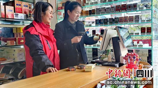 稻城县烟草公司工作人员指导傅金梅(左)使用智慧收银机。稻城县烟草公司供图 稻城县烟草公司工作人员指导傅金梅(左)使用智慧收银机。稻城县烟草公司供图