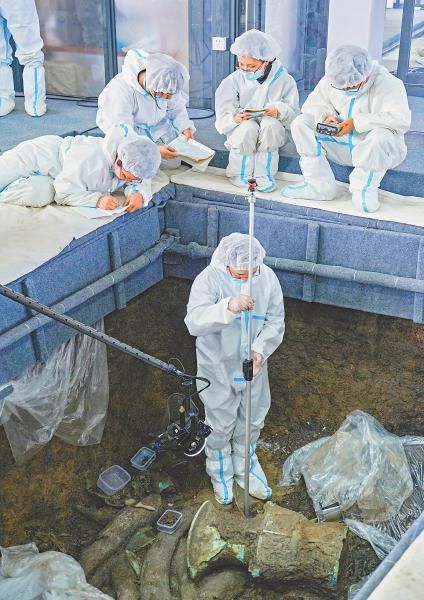 三星堆博物馆工作人员正在用全球仪,结合全球定位系统,测量器物出土点位。 记者 向宇 摄 三星堆博物馆工作人员正在用全球仪,结合全球定位系统,测量器物出土点位。 记者 向宇 摄