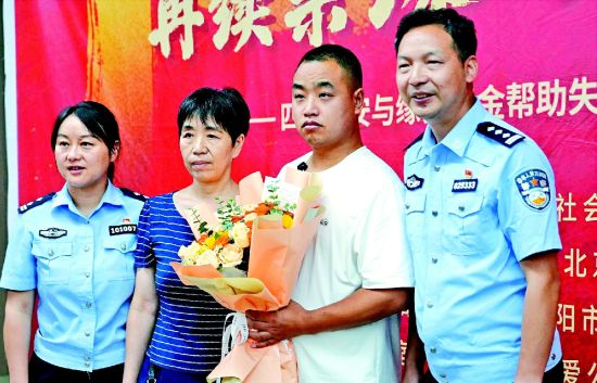 认亲现场,胡祥雨(右一)等民警与尹大姐母子二人合影 记者邓孝禹摄 认亲现场,胡祥雨(右一)等民警与尹大姐母子二人合影 记者邓孝禹摄
